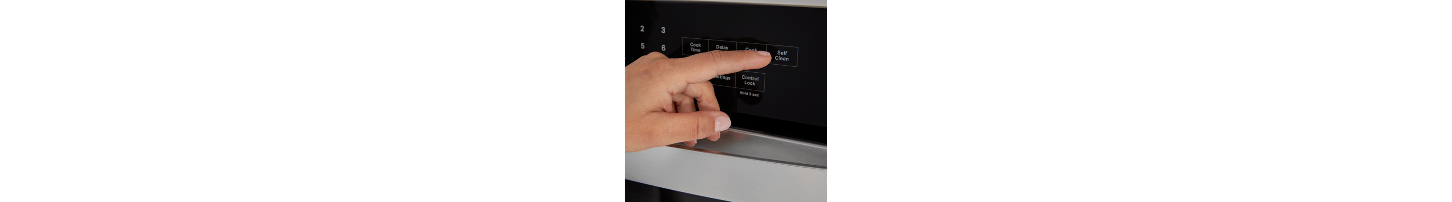Person selecting a bake setting on a Whirlpool® oven