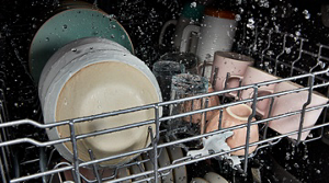 A closeup of dishes being cleaned in a dishwasher