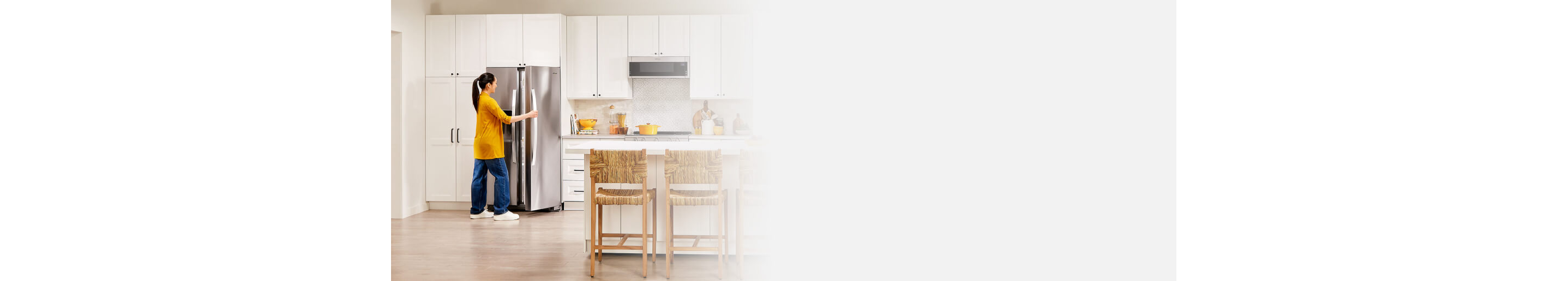 Person opening a side-by-side refrigerator