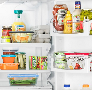 A Whirlpool® refrigerator loaded with a variety of foods